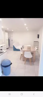 a kitchen with a table and chairs in a room at Grand Appartement, 2 ou 3 ou 4 pieces, tramway sur place, proche gare sncf St Augustin 5 min, aéroport à 7 min, plage ou Allianz riviera 10 min, palais nikaia 2 min , supermarché sur place, parking possible si disponible ou payant à 1000 metre in Nice