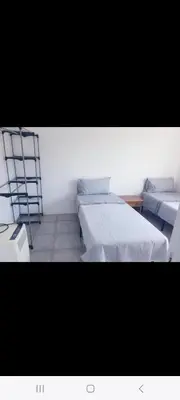 a room with two beds and a ladder in it at Grand Appartement, 2 ou 3 ou 4 pieces, tramway sur place, proche gare sncf St Augustin 5 min, aéroport à 7 min, plage ou Allianz riviera 10 min, palais nikaia 2 min , supermarché sur place, parking possible si disponible ou payant à 1000 metre in Nice