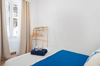 a bed with towels on it in a room with a window at Nice Renting - 5bFRANCE - Luxurious Apartment Place Massena Promenade des Anglais in Nice