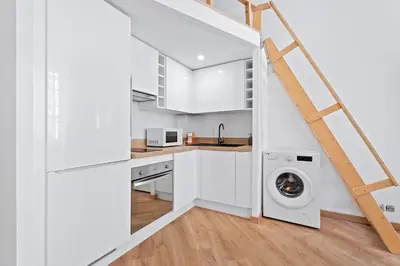 a kitchen with white cabinets and a washer and dryer at Nice Renting - 5bFRANCE - Luxurious Apartment Place Massena Promenade des Anglais in Nice