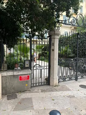a black iron gate with a sign on it at Coeur de Nice - Plage et Centre in Nice