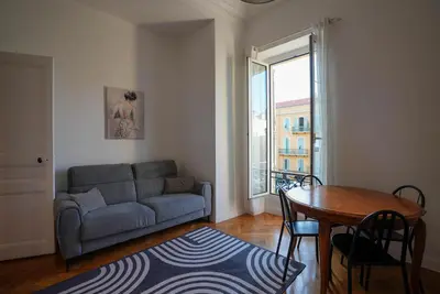 a living room with a couch and a table at Coeur de Nice - Plage et Centre in Nice