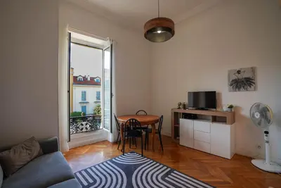 a living room with a table and a window at Coeur de Nice - Plage et Centre in Nice