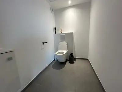 a bathroom with a toilet in a white room at Sea Breeze By Avecoeur in Nice