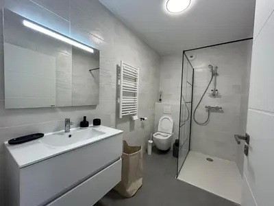 a white bathroom with a sink and a toilet at Sea Breeze By Avecoeur in Nice