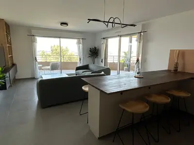 a kitchen and living room with a couch and a table at Sea Breeze By Avecoeur in Nice