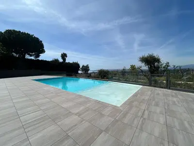 a swimming pool in a yard with a tile floor at Sea Breeze By Avecoeur in Nice