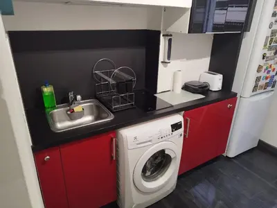 a small kitchen with a sink and a washing machine at Private Room in Shared Apartment in the Center of Nice in Nice