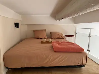 a bedroom with a bed with two candles on it at Le Bosio-studio avec vue mer in Nice