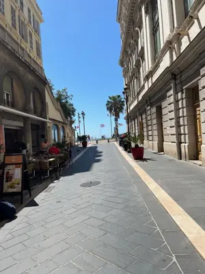 an empty street with tables and chairs in a city at Le Bosio-studio avec vue mer in Nice