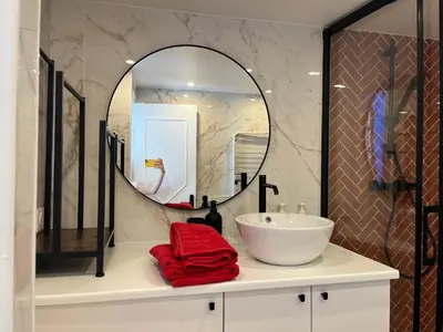 a bathroom with a sink and a mirror at Le Bosio-studio avec vue mer in Nice
