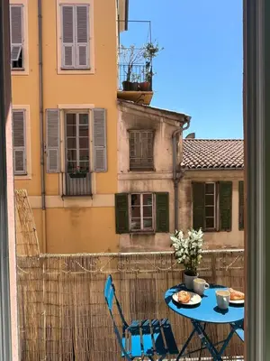 a view of a balcony with a table and chairs at Le Bosio-studio avec vue mer in Nice