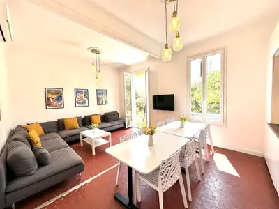 a living room with a couch and a table at Villa Lila in Nice