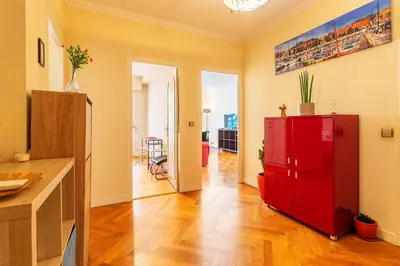 a living room with a red cabinet and a kitchen at LE CAPITOL 2 AP4421 By Riviera Holiday Homes in Nice