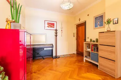 a living room with wooden floors and a red cabinet at LE CAPITOL 2 AP4421 By Riviera Holiday Homes in Nice