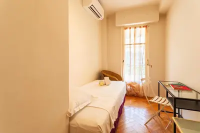 a room with a bed and a desk and a window at LE CAPITOL 2 AP4421 By Riviera Holiday Homes in Nice