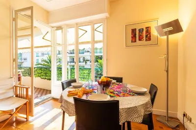 a dining room with a table and chairs at LE CAPITOL 2 AP4421 By Riviera Holiday Homes in Nice