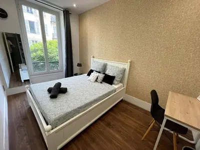 a bedroom with a bed and a window at Appart T3 Clim Hypercentre in Nice