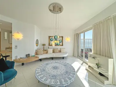a living room with a couch and a table at Sea Front Penthouse Cote d Azur in Nice