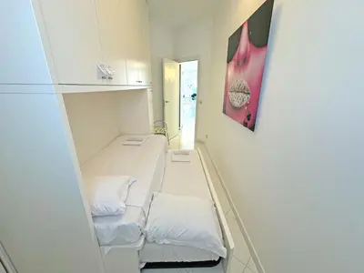 a small room with two beds and a wall at Sea Front Penthouse Cote d Azur in Nice