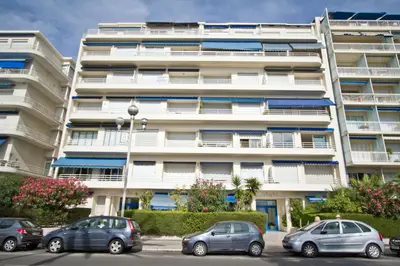 a large white building with cars parked in front of it at Sea Front Penthouse Cote d Azur in Nice