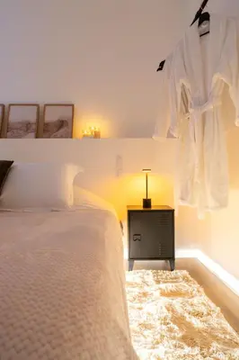 a bedroom with a bed and a dresser with a robe hanging above it at Riviera Bliss in Nice