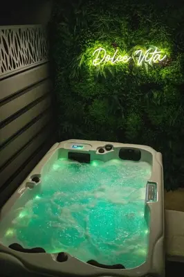 a bath tub in a bathroom with a sign at Dolce Vita, Spa, Cagnes Sur Mer in Cagnes-sur-Mer