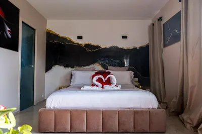 a stuffed animal is sitting on top of a bed at Dolce Vita, Spa, Cagnes Sur Mer in Cagnes-sur-Mer
