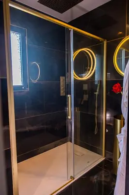 a shower with a glass door in a room at Dolce Vita, Spa, Cagnes Sur Mer in Cagnes-sur-Mer