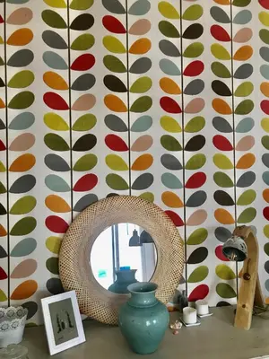 a mirror on a table in a room with a wall at Le grand Niçois in Nice