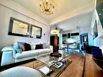 a living room with a couch and a table at ApartHotel Riviera - LE PETIT BALCON DE L'OPERA - Old Town Promenade des Anglais in Nice