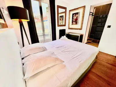 a white bed in a room with a window at ApartHotel Riviera - LE PETIT BALCON DE L'OPERA - Old Town Promenade des Anglais in Nice