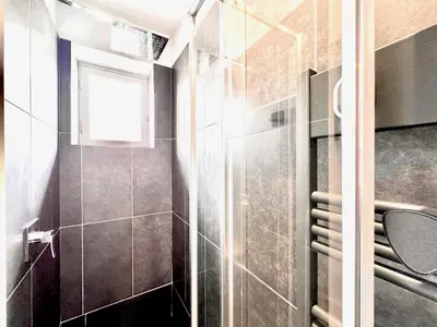a bathroom with a shower with a glass door at ApartHotel Riviera - LE PETIT BALCON DE L'OPERA - Old Town Promenade des Anglais in Nice