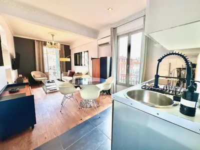 a kitchen and living room with a sink and a table at ApartHotel Riviera - LE PETIT BALCON DE L'OPERA - Old Town Promenade des Anglais in Nice