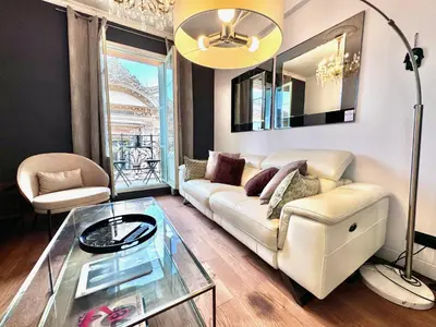 a living room with a couch and a glass table at ApartHotel Riviera - LE PETIT BALCON DE L'OPERA - Old Town Promenade des Anglais in Nice