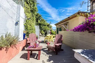 two chairs and a table on a patio with flowers at PENTHOUSE 2Bedroms 6pax- Views 45m2 Terrace in Nice