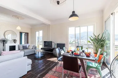 a living room with a couch and a table at PENTHOUSE 2Bedroms 6pax- Views 45m2 Terrace in Nice