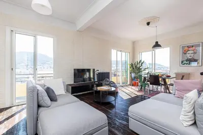 a living room with a couch and a tv at PENTHOUSE 2Bedroms 6pax- Views 45m2 Terrace in Nice