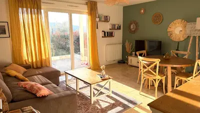 a living room with a couch and a coffee table at Superbe appartement lumineux en rez de jardin in Saint-Laurent-du-Var
