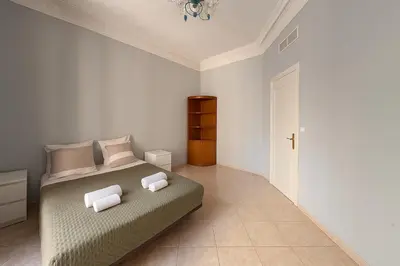 a bedroom with a bed with two pillows on it at Spacieux appartement climatisé centre Nice in Nice