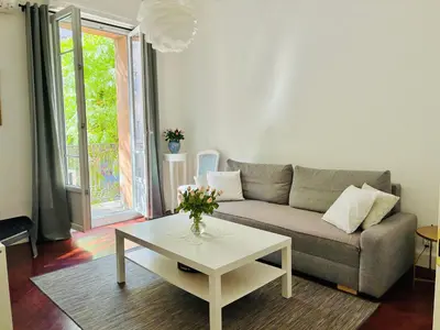 a living room with a couch and a table at 2P Moderne Riquier proche Port, Gare, Tramway in Nice
