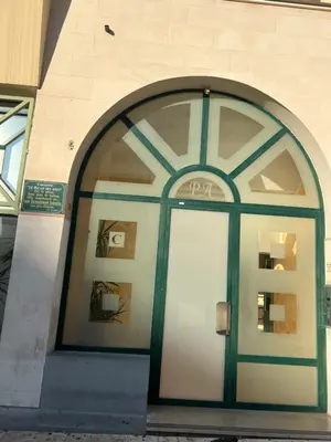 a door to a building with a sign on it at La Terrasse de Palais des Arts in Nice
