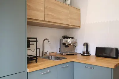 a kitchen with a sink and a microwave at Appartement de charme centre vieux village in Villefranche-sur-Mer