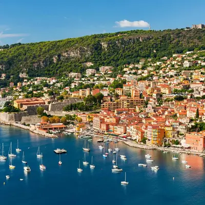 a group of boats in a harbor with a city at Olive Grove Retreat in La Trinité