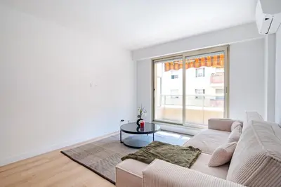 a white living room with a couch and a table at Near old town and apartment fully renovated in Nice