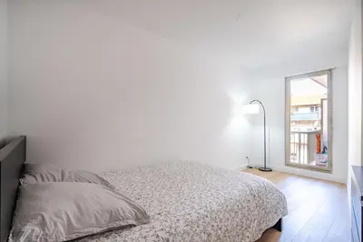 a white bedroom with a bed and a window at Near old town and apartment fully renovated in Nice