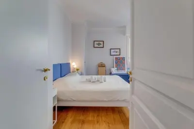 a bedroom with a bed in a white room at LE 3 PROMENADE AP4424 By Riviera Holiday Homes in Nice