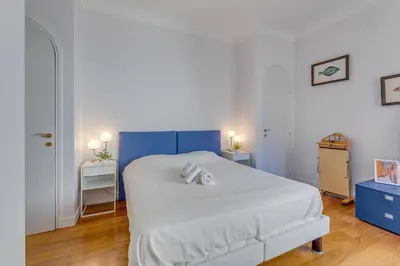 a bedroom with a white bed with two towels on it at LE 3 PROMENADE AP4424 By Riviera Holiday Homes in Nice