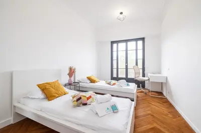 two beds in a room with a desk at MY CASA - OLIVETTO - Superb city center apartment with AC in Nice