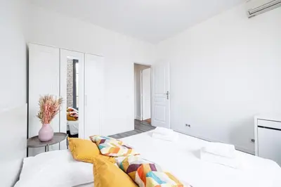 a white bedroom with a bed with a yellow blanket at MY CASA - OLIVETTO - Superb city center apartment with AC in Nice